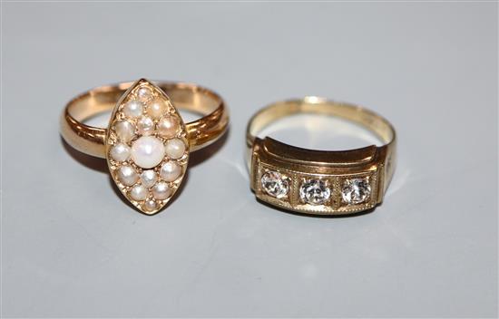 A yellow metal and seed pearl set marquise shaped ring and a 333 yellow metal ring.